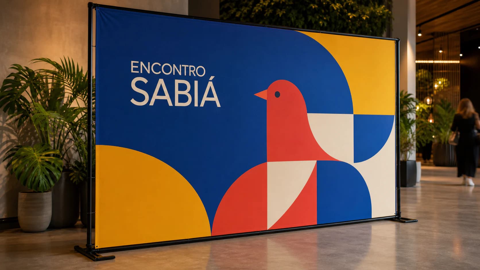 Backdrop colorido do evento fictício Encontro Sabiá montado em área para fotos